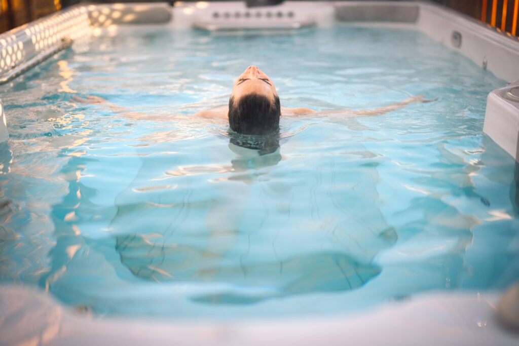 woman using a hydropool swim spa